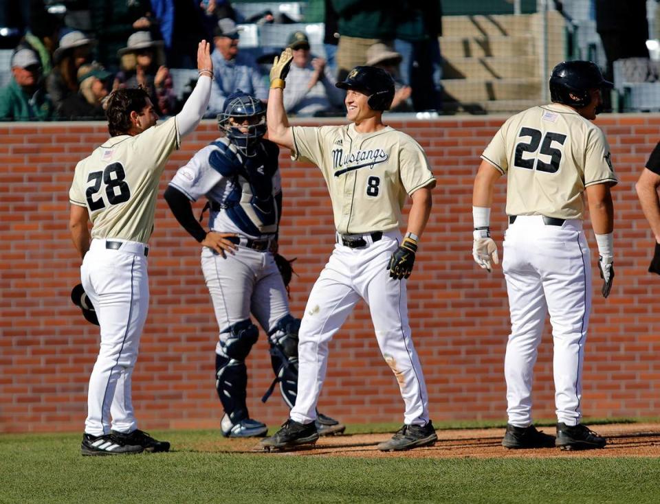 Cal Poly’s Ryan Fenn (8) gets a high five from Wyatt King (28) in the Mustangs’ 9-7 loss to UC Irvine in a Big West Conference baseball game at Baggett Stadium, San Luis Obispo on March 25, 2023.