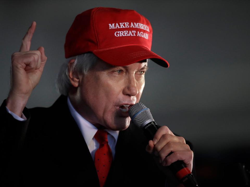 Attorney Lin Wood, a member of President Donald Trump's legal team, gestures while speaking during a rally on Dec. 2, 2020, in Alpharetta, Ga.