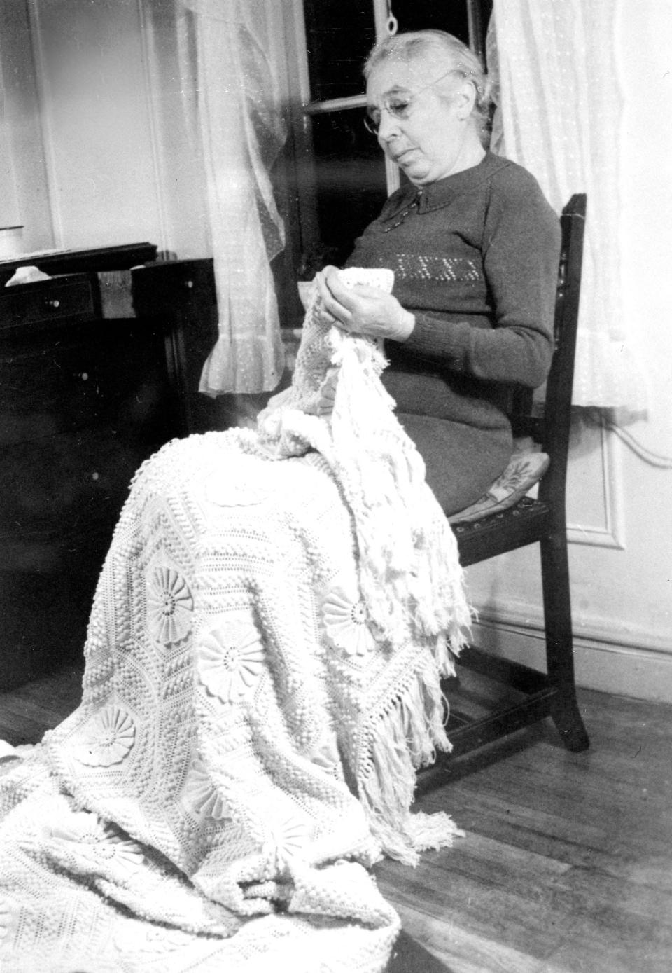 Yetta Dine, the mother of poet Stanley Kunitz, sewing.