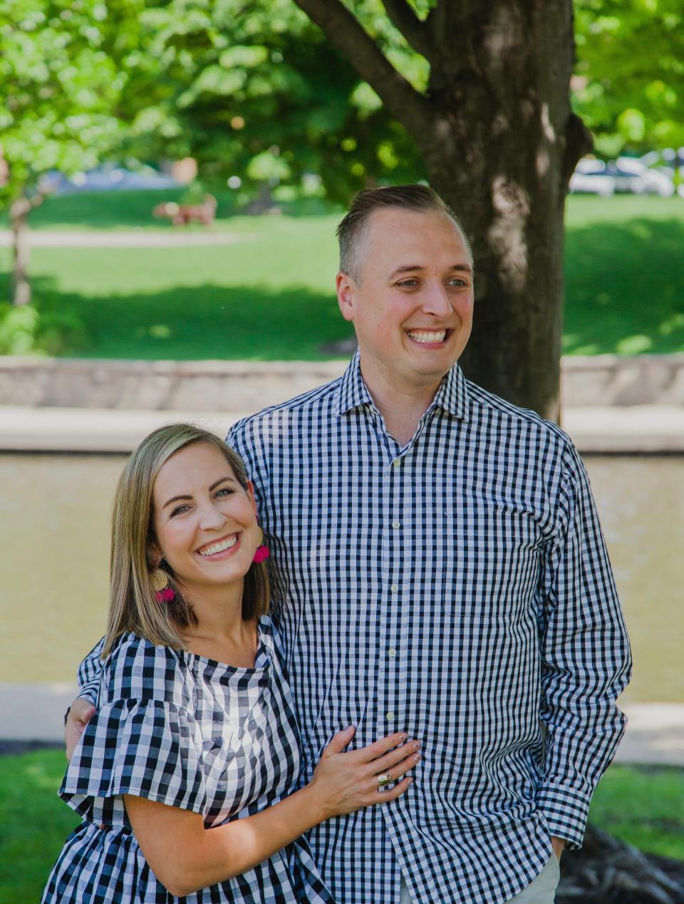 The author, left, and her husband standing outside. She is wearing a black and white gingham short-sleeve shirt and he is wearing a checked button-up..