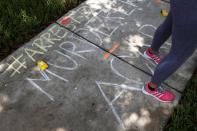 Chalk markings done by protesters cover the sidewalk outside the Florida home of former Minneapolis police officer Derek Chauvin, in Orlando