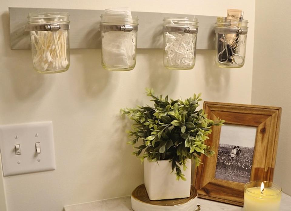 <body> <p>From Q-tips to floss, this off-the-wall <a rel="nofollow noopener" href=" https://www.bobvila.com/articles/5-things-to-do-with-mason-jars/#.VrJUpmTysy4?bv=yahoo" target="_blank" data-ylk="slk:mason jar;elm:context_link;itc:0;sec:content-canvas" class="link ">mason jar</a> organizer keeps countertop clutter out of sight and in style. To copy the look, secure a wooden board to the wall with picture frame hangers. Affix mason jars to the board with pipe clamps, and fill them with bath essentials to start seeing the glass (jars) half full!</p> <p><strong>Related: <a rel="nofollow noopener" href=" http://www.bobvila.com/slideshow/12-easy-ways-to-boost-bathroom-storage-16467#.VrvWGGTysy4?bv=yahoo" target="_blank" data-ylk="slk:12 Easy Ways to Boost Bathroom Storage;elm:context_link;itc:0;sec:content-canvas" class="link ">12 Easy Ways to Boost Bathroom Storage</a> </strong> </p> </body>