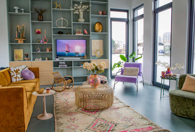 Pastel living room with sky blue wall unit on houseboat.