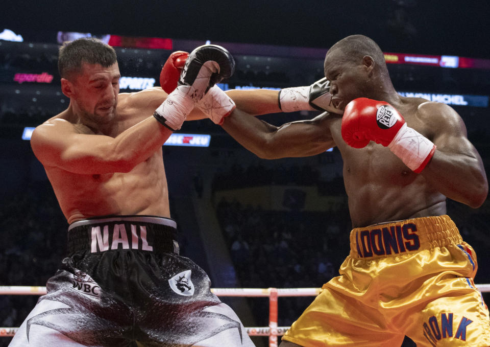 Oleksandr Gvozdyk (L) lands a right on Adonis Stevenson during their light heavyweight WBC championship fight Saturday in Quebec City. Gvozdyk won by knockout. (AP)