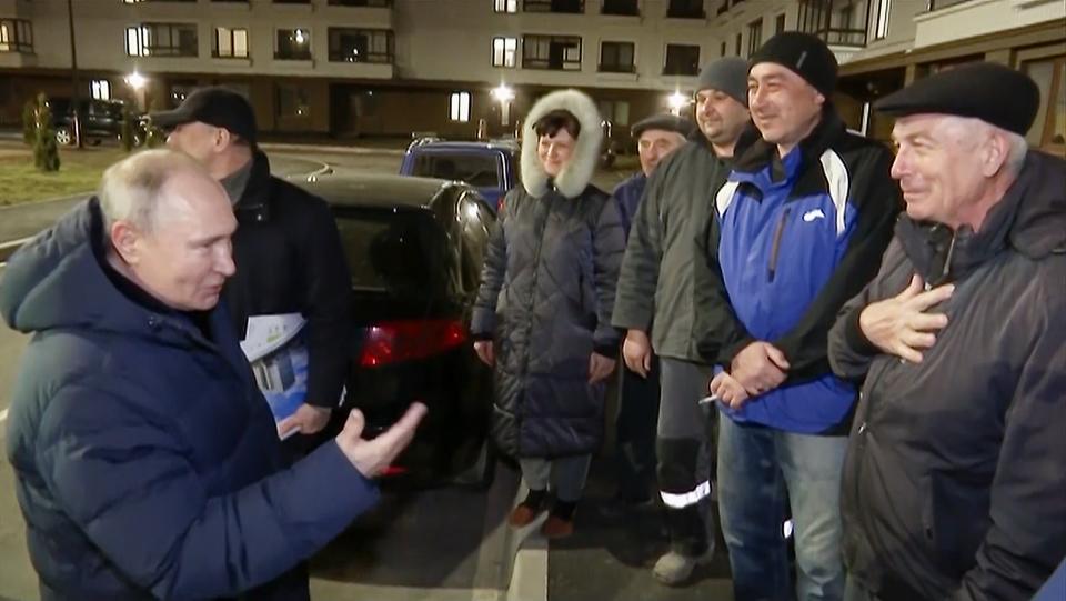 In this photo taken from video released by Russian TV Pool on Sunday, March 19, 2023, Russian President Vladimir Putin talks with local residents during his visit to Mariupol in Russian-controlled Donetsk region, Ukraine. Putin has traveled to Crimea to mark the ninth anniversary of the Black Sea peninsula's annexation from Ukraine. (Pool Photo via AP)