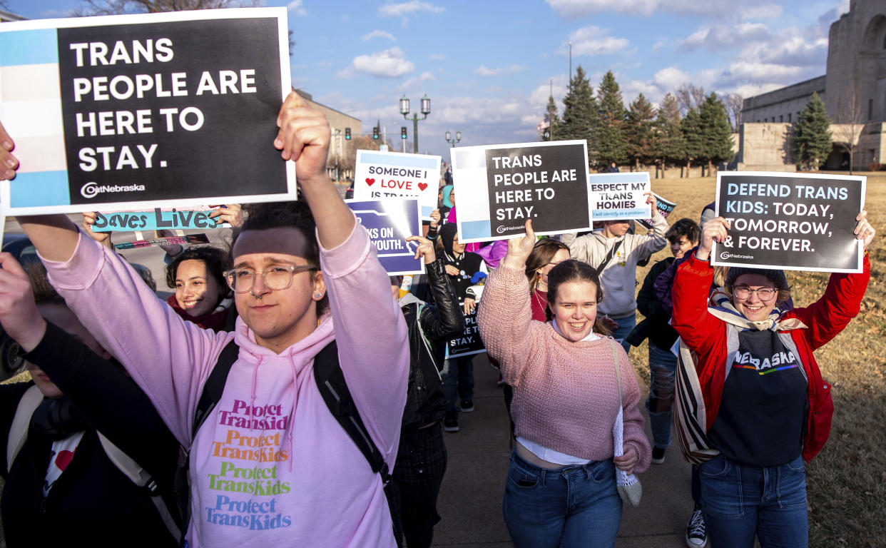 People march around the Nebraska state Capitol during a Transgender Day of Visibility rally, Friday, March 31, 2023, in Lincoln, Neb. (Larry Robinson/Lincoln Journal Star via AP)