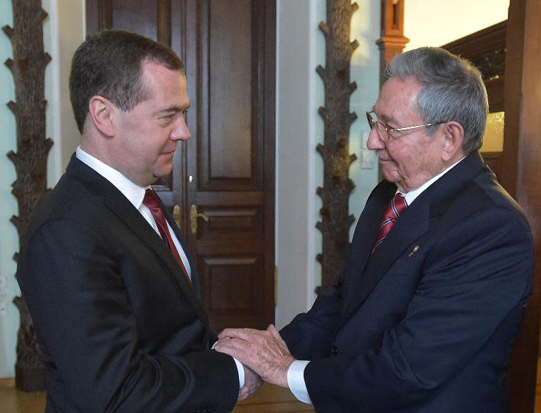 Russian Prime Minister Dmitry Medvedev (left) shakes hands with Cuban President Raul Castro during their meeting in Moscow, on May 6, 2015