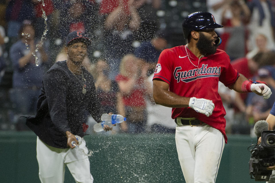 Cleveland Guardians' Amed Rosario is sprayed by an unidentified teammate after the team's win in the 15th inning of the second game of a baseball doubleheader against the Minnesota Twins in Cleveland, early Sunday, Sept. 18, 2022. (AP Photo/Phil Long)