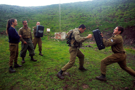 Female Israeli soldier, Lotem Stapleton (L), a physical education officer, oversees a training session in Krav Maga, an Israeli self-defence technique, at a military base in the Israeli-occupied Golan Heights March 1, 2017. REUTERS/Nir Elias