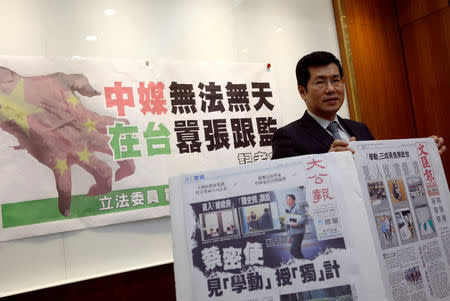 FILE PHOTO: Democratic Progressive Party lawmaker Lo Chih Cheng poses with copies of Hong Kong's Ta Kung Pao and Wen Wei Po newspapers after a news conference in Taipei, Taiwan January 18, 2019. REUTERS/Tyrone Siu/File Photo