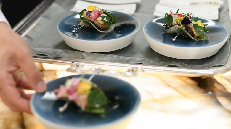 Three plated food on metal trays