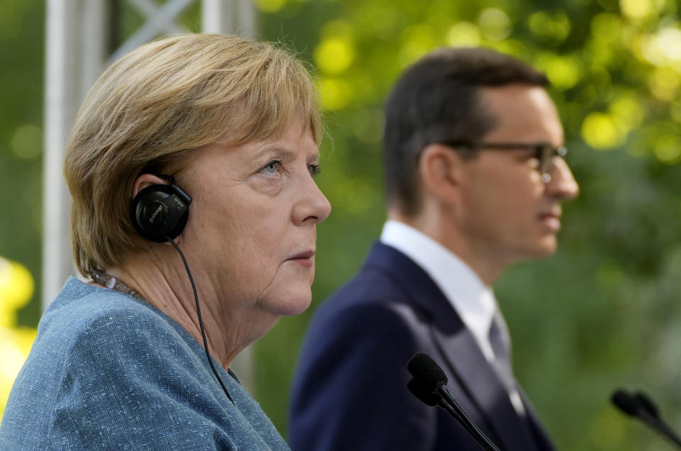 German Chancellor Angela Merkel, left, and Poland's Prime Minister Mateusz Morawiecki give a press conference in Warsaw, Poland, Saturday, Sept.11, 2021.Merkel is visiting the Polish capital Morawiecki at a time when Poland faces migration pressure on its eastern border with Belarus. (AP Photo/Czarek Sokolowski)