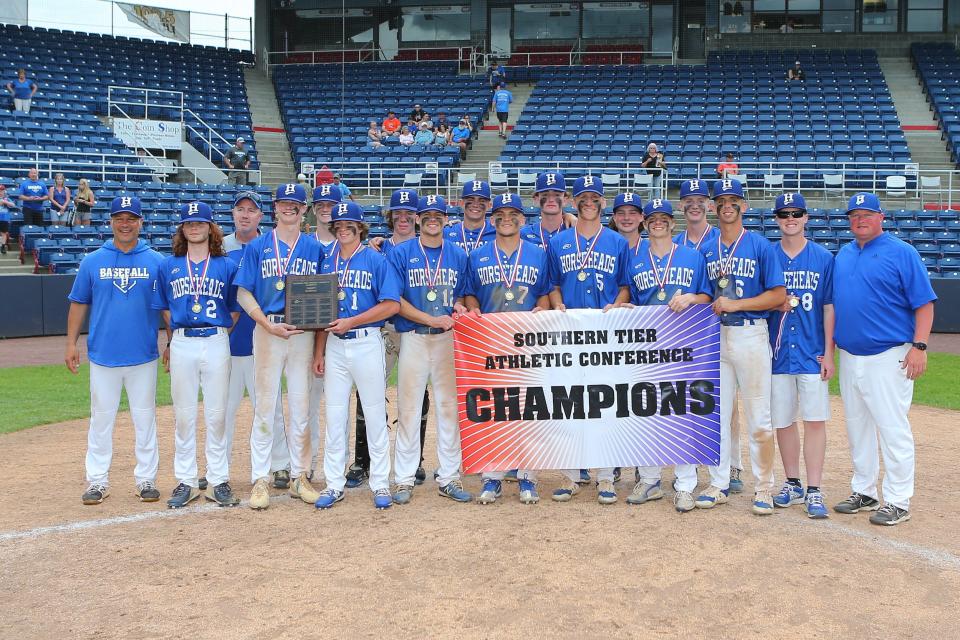 2022 STAC Baseball Champions from Horseheads pose with banner and plaque after beating UE 10-6.