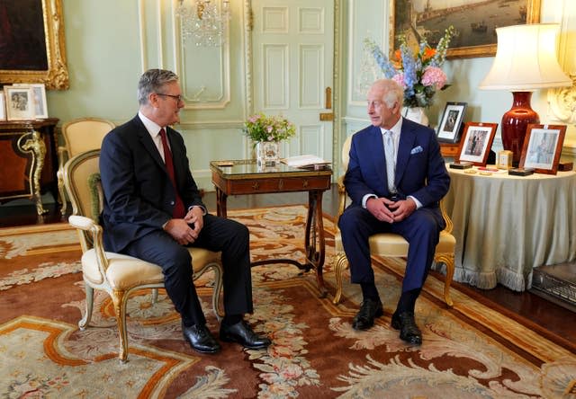 Sir Keir Starmer sitting down with the King with a small table between them