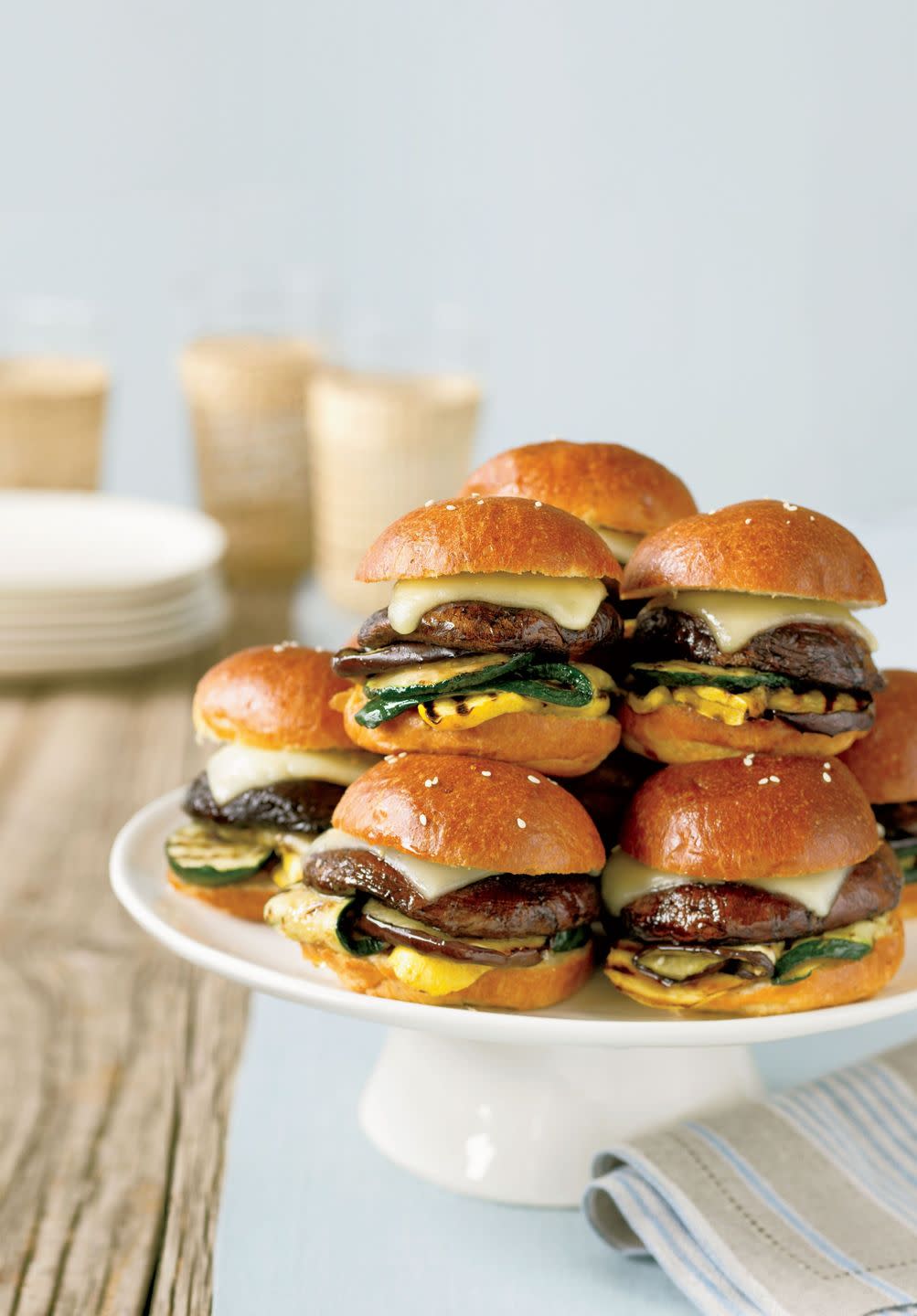 mini portobello burgers stacked on a white serving dish