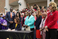 Michigan Gov. Gretchen Whitmer signs legislation, Monday, May 22, 2023, in Royal Oak, Mich. The package of legislation being signed will create extreme risk protection orders, which authorize family, police officers, or medical professionals to seek a court order to temporarily keep guns out of the hands of someone who represents a danger to themselves or others. (AP Photo/Carlos Osorio)