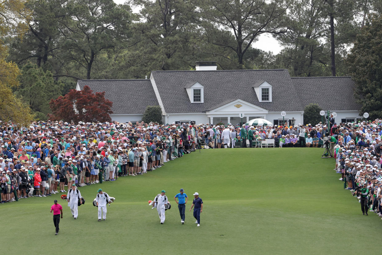 AUGUSTA, GEORGIA - APRIL 07: The group of Tiger Woods, Joaquin Niemann of Chile, and Louis Oosthuizen of South Africa walks off the first tee during the first round of the Masters at Augusta National Golf Club on April 07, 2022 in Augusta, Georgia. (Photo by Jamie Squire/Getty Images)