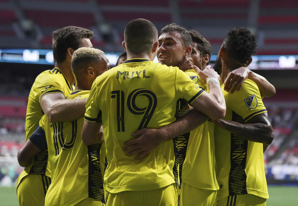 Nashville FC's Jack Maher, centerright, celebrates his goal against the Vancouver Whitecaps with teammates during first-half MLS soccer match action in Vancouver, British Columbia, Saturday, Aug. 27, 2022. (Darryl Dyck/The Canadian Press via AP)