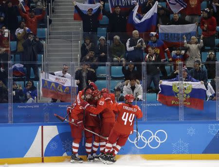 Ice Hockey - Pyeongchang 2018 Winter Olympics - Men's Quarterfinal Match - Olympic Athletes from Russia v Norway - Gangneung Hockey Centre, Gangneung, South Korea - February 21, 2018 - Ivan Telegin, an Olympic Athlete from Russia (2nd from L, obscured), celebrates his third period goal with teammates and fans. REUTERS/David W. Cerny