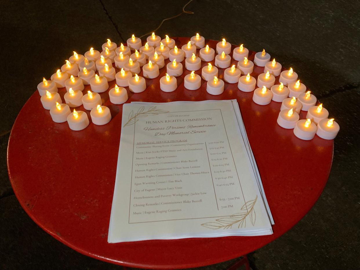 The city of Eugene offers electronic candles at a memorial vigil for the 71 people who died while homeless in Lane County in 2023.