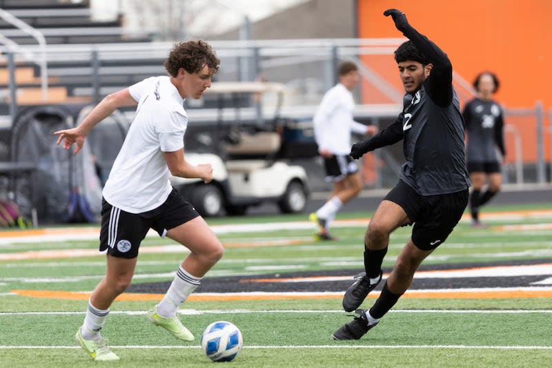 Park City Miners David Dellenbach (9) dribbles the ball past Murray Spartans Abdulmalik Shaher (2) during a game at Murray High School in Murray on Friday, April 5, 2024.