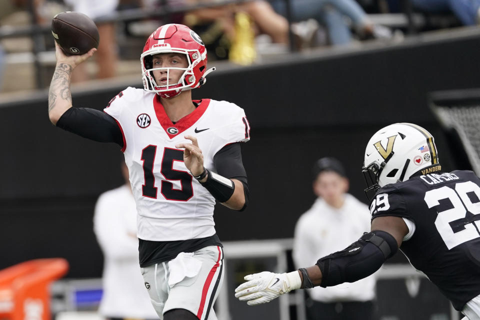 Georgia quarterback Carson Beck (15) looks to throw a pass past Vanderbilt defensive back Miles Capers, right in the first half of an NCAA college football game Saturday, Oct. 14, 2023, in Nashville, Tenn. (AP Photo/George Walker IV)