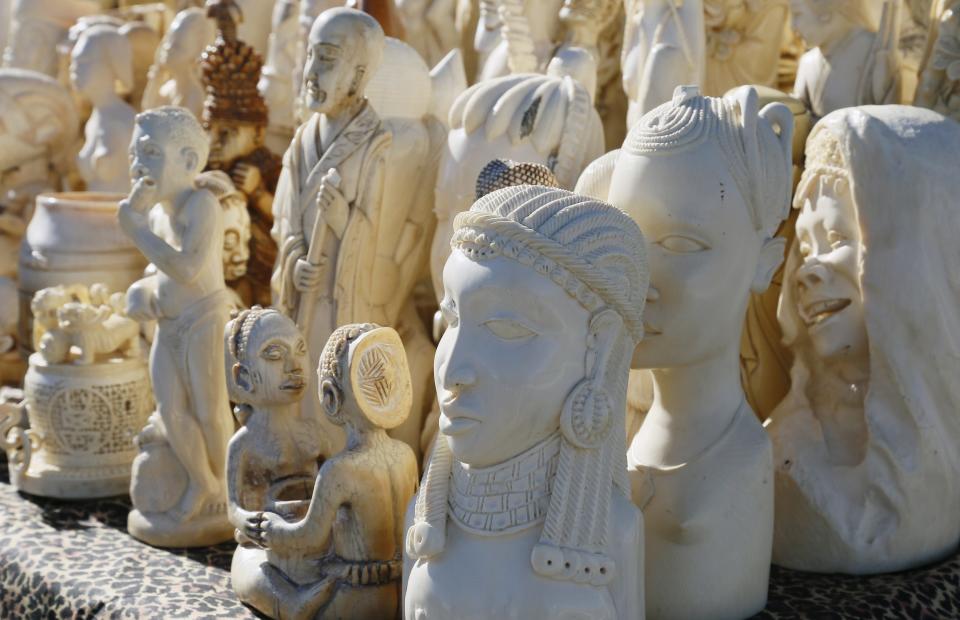 Dozens of confiscated carved elephant ivory sculptures are displayed before 6 tons of ivory was crushed, in Denver, Colorado