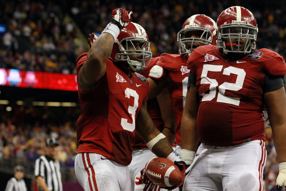 NEW ORLEANS, LA - JANUARY 09: Trent Richardson #3 of the Alabama Crimson Tide celebrates with Alfred McCullough #52 after scoring a touchdown in the fourth quarter against the Louisiana State University Tigers during the 2012 Allstate BCS National Championship Game at Mercedes-Benz Superdome on January 9, 2012 in New Orleans, Louisiana. (Photo by Ronald Martinez/Getty Images)