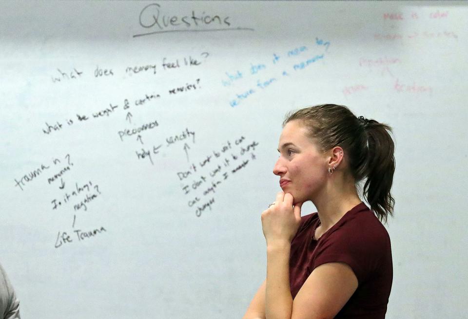 Dancer Anna Baugham ponders the subject of memory loss during a brainstorming session for Dominic Moore-Dunson's project "The Remember Balloons" at Guzzetta Hall Dec. 7 in Akron.