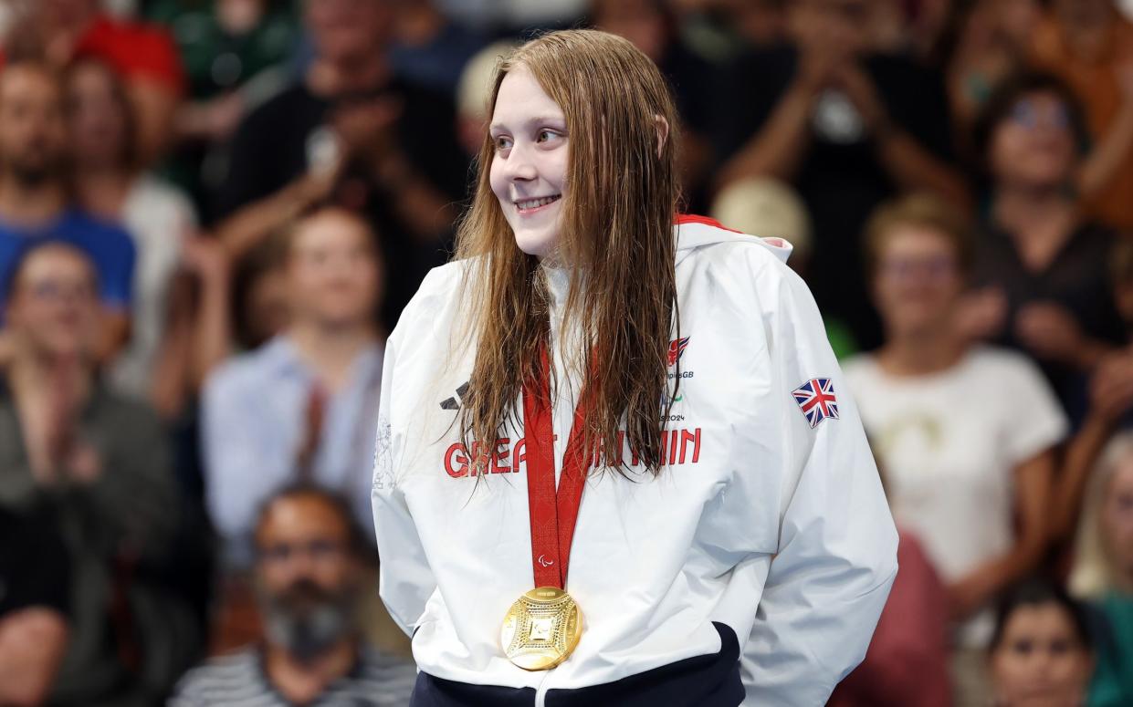 Poppy Maskill of Team Great Britain is seen on the podium with her Gold medal from the Women's 100m Butterfly - S14