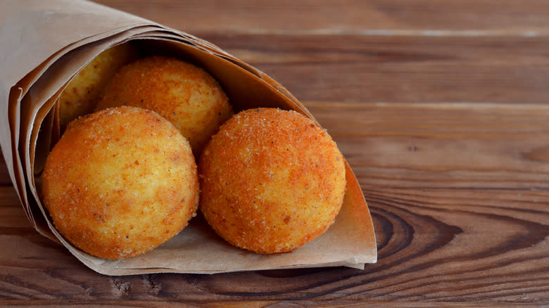 Arancini in paper on table