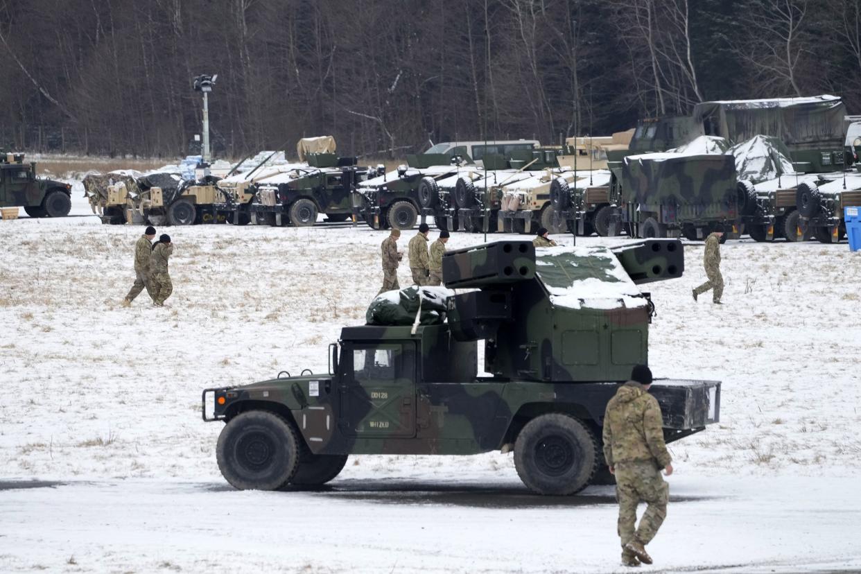 U.S. soldiers walk at a local airport in Arlamow, southeastern Poland, near the border with Ukraine, on Monday, Feb. 28, 2022. President Vladimir Putin dramatically escalated East-West tensions by ordering Russian nuclear forces put on high alert following new crippling Western sanctions that forced his Central Bank to sharply raise its key rate Monday to save the ruble from collapse.