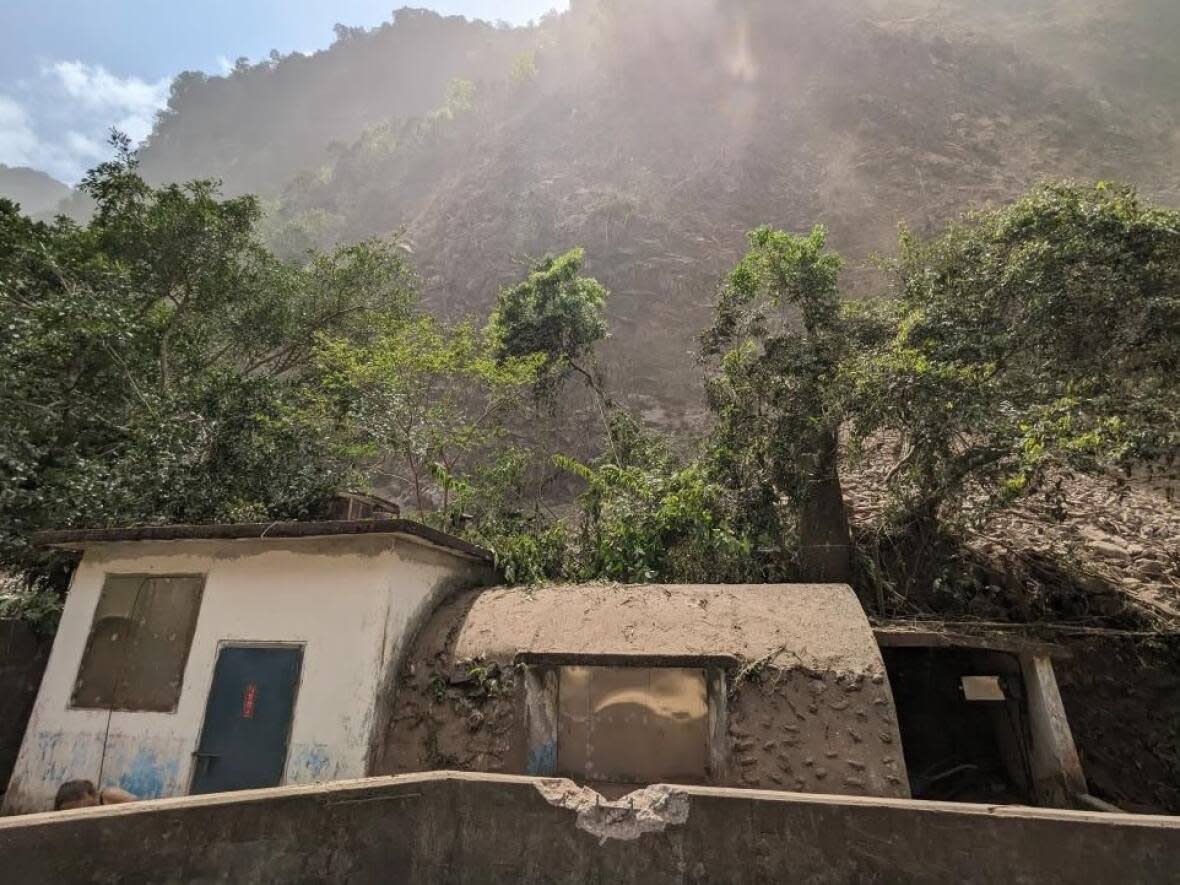 Lelia Lemay of Montreal and her boyfriend Brandon Iwanyshyn of Edmonton sheltered from falling rocks by huddling near this building in Toroko Gorge in eastern Taiwan. (Submitted by Brandon Iwanyshyn - image credit)