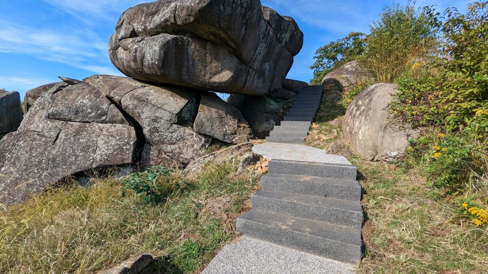 New steps wind their way through the boulders of Devil's Den at the Gettysburg National Military Park on October 6, 2022. Before the construction, soil had eroded from underneath a walkway, and staircases had been worn and weathered over time. Social trails - shortcuts created by tourists - had exacerbated erosion.