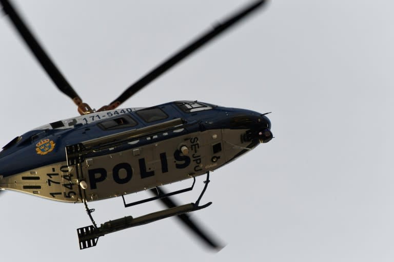 A Police helicopter flys overhead at the scene where a truck crashed into the Ahlens department store at Drottninggatan in central Stockholm, April 7, 2017