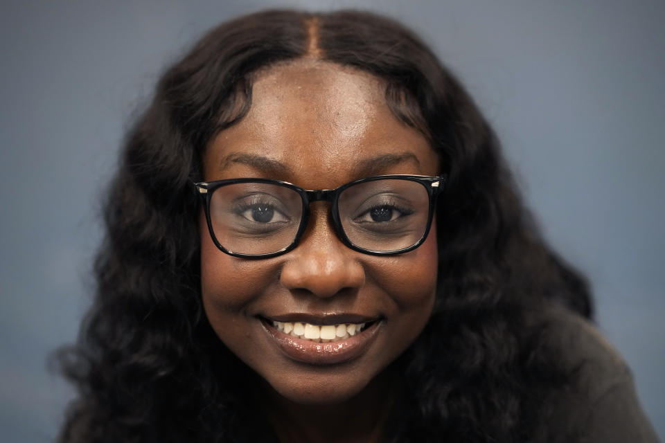 Hillary Amofa sits for a portrait after her step team practice at Lincoln Park High School Friday, March 8, 2024, in Chicago. When she started writing her college essay, Amofa told the story she thought admissions offices wanted to hear. She wrote about being the daughter of immigrants from Ghana, about growing up in a small apartment in Chicago. She described hardship and struggle. Then she deleted it all. "I would just find myself kind of trauma-dumping," said the 18 year-old senior, "And I'm just like, this doesn't really say anything about me as a person." (AP Photo/Charles Rex Arbogast)