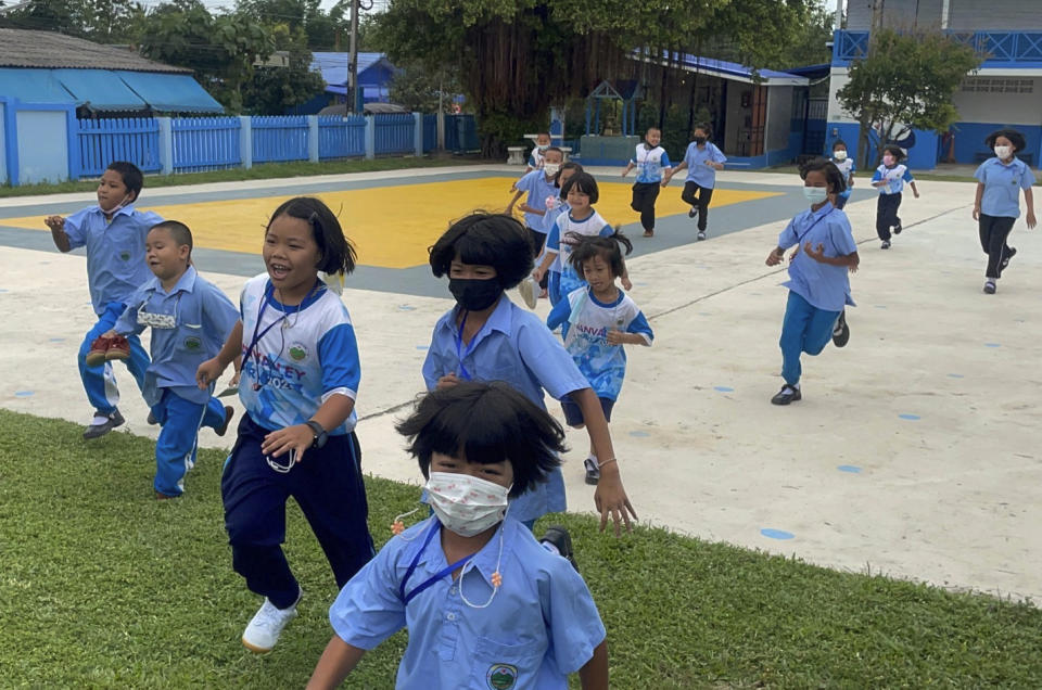 Teachers from Wale School directed students from their classrooms to shelters in Tak Province, Thailand, Thursday, June 30, 2022. A Myanmar fighter jet crossed the border into Thailand's airspace on Thursday, prompting Thai air force jets to scramble and officials to order the evacuation of villages and classrooms, officials said. (AP Photo/Chiravut Rungjumrusrussamee)