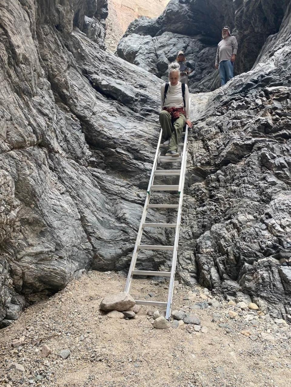 Members of the Coachella Valley Hiking Club inspect a ladder in Ladders Canyon.