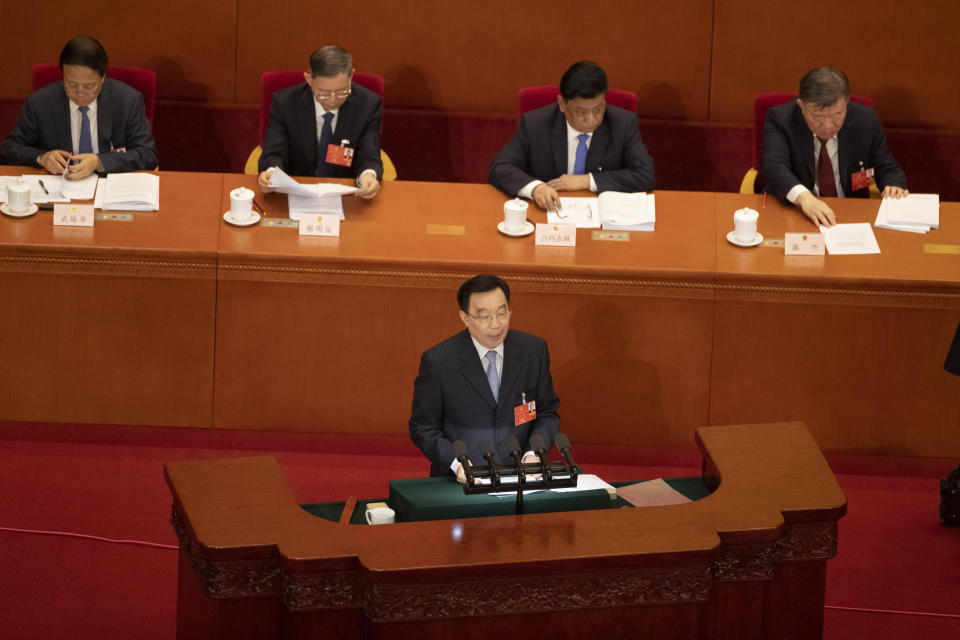 In this photo taken Friday, May 22, 2020, Wang Chen, vice chairman of the Standing Committee of the National People's Congress (NPC) explains the draft decision on establishing and improving the legal system and enforcement mechanisms for the Hong Kong Special Administrative Region (HKSAR) to safeguard national security submitted to China's national legislature for deliberation during the opening session of the National People's Congress held at the Great Hall of the People in Beijing. China is taking matters into its own hands after last year’s tumultuous anti-government protests in Hong Kong that often descended into tear gas-filled clashes. (AP Photo/Ng Han Guan)