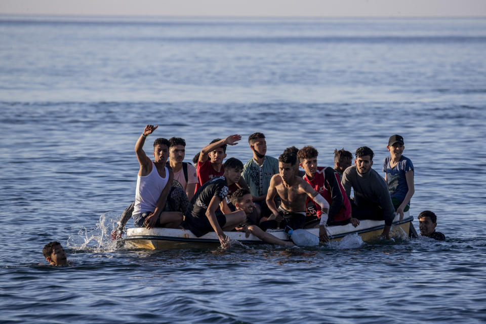 Migrants arrive at the Spanish enclave of Ceuta, near the border of Morocco and Spain, Wednesday, May 19, 2021. Spanish officials are acknowledging for the first time that the unprecedented migrant crisis has been triggered by an angry Rabat at Madrid's decision to provide medical treatment to the militant boss of the Polisario Front. (AP Photo/Bernat Armangue)