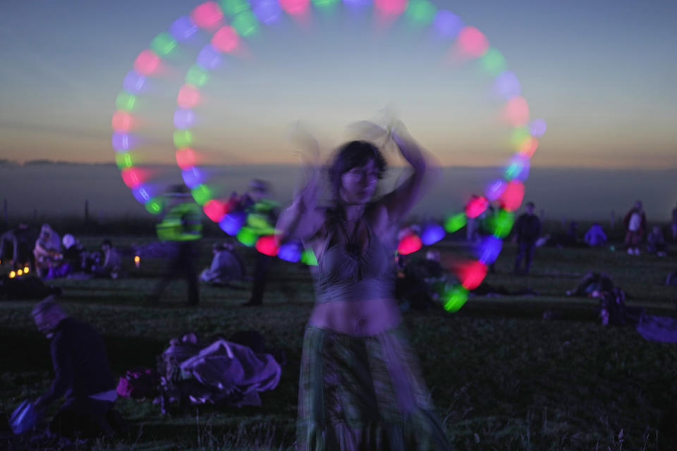 Revelers gather at the ancient stone circle Stonehenge to celebrate the Summer Solstice, the longest day of the year, near Salisbury, England, Wednesday, June 21, 2023. (AP Photo/Kin Cheung)