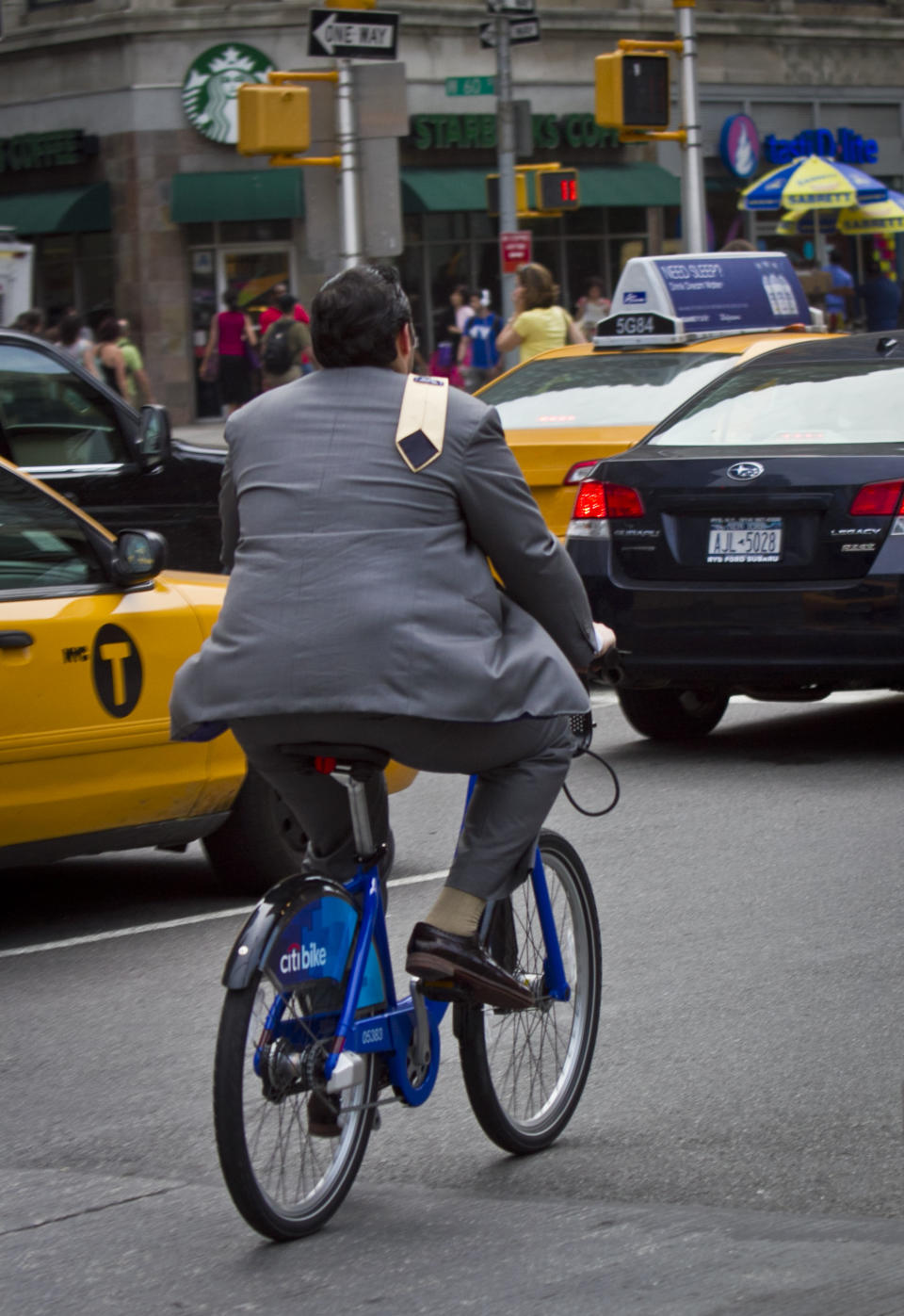 In this Tuesday, June 25, 2013, photo, a biker rides without a helmet on a Citibike, as part of New York City's bike sharing system, in New York. Under Mayor Bloomberg, the city has cracked down on smoking, fatty foods and sugary drinks for health concerns, but the nations largest bike-share program allow riders without helmets. (AP Photo/Bebeto Matthews)