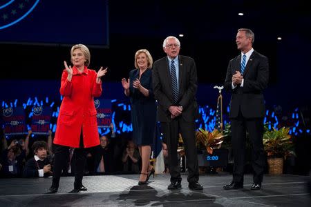 (L-R) Hillary Clinton, Iowa Democratic Chairwoman Andy McGuire, Bernie Sanders and Martin O'Malley, greet the crowd at the Jefferson-Jackson Dinner in Des Moines, Iowa on October 24, 2015. REUTERS/Mark Kauzlarich