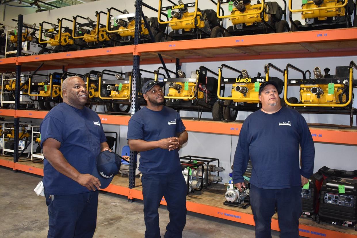 Clean Harbors Cooperative team members take inventory of surplus hazmat equipment and supplies in the collective’s garage. Pictured from left to right are Kelvin Jones, Jameel Pleasant, and Jason Pevonis.