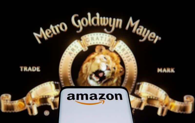 FILE PHOTO: Smartphone with Amazon logo is seen in front of displayed MGM logo in this illustration taken