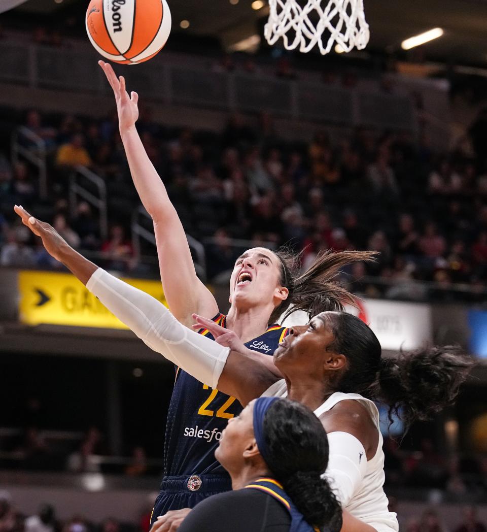 Indiana Fever guard Caitlin Clark (22) goes in for a lay-up against Atlanta Dream forward Cheyenne Parker-Tyus (32) on Thursday, May 9, 2024, during the preseason game against the Atlanta Dream at Gainbridge Fieldhouse in Indianapolis.