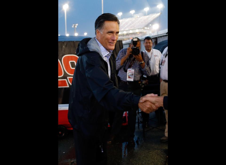 RICHMOND, VA - SEPTEMBER 08:  Republican presidential candidate, former Massachusetts Gov. Mitt Romney shakes hands with a NASCAR official during a rain delay before the start of the NASCAR Sprint Cup Series Federated Auto Parts 400 at Richmond International Raceway on September 8, 2012 in Richmond, Virginia.  (Photo by Chris Graythen/Getty Images)