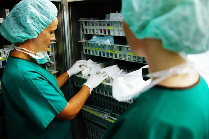 Two healthcare professionals in front of a medical supply closet