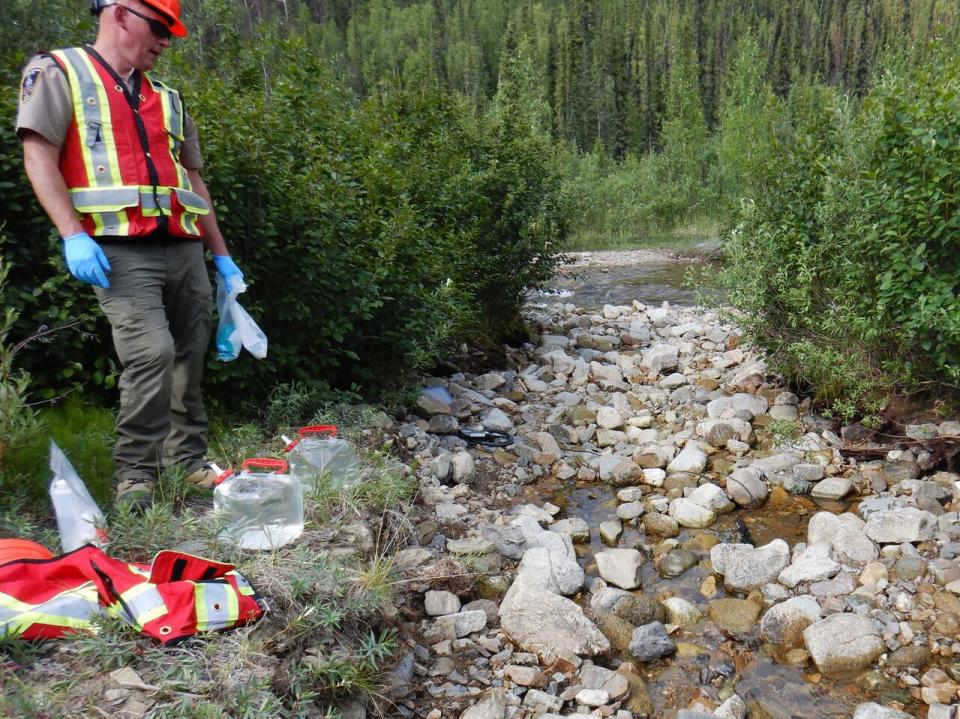 Collecting water samples at the Eagle mine site in Yukon after a heap leach pad failure, June 2024.