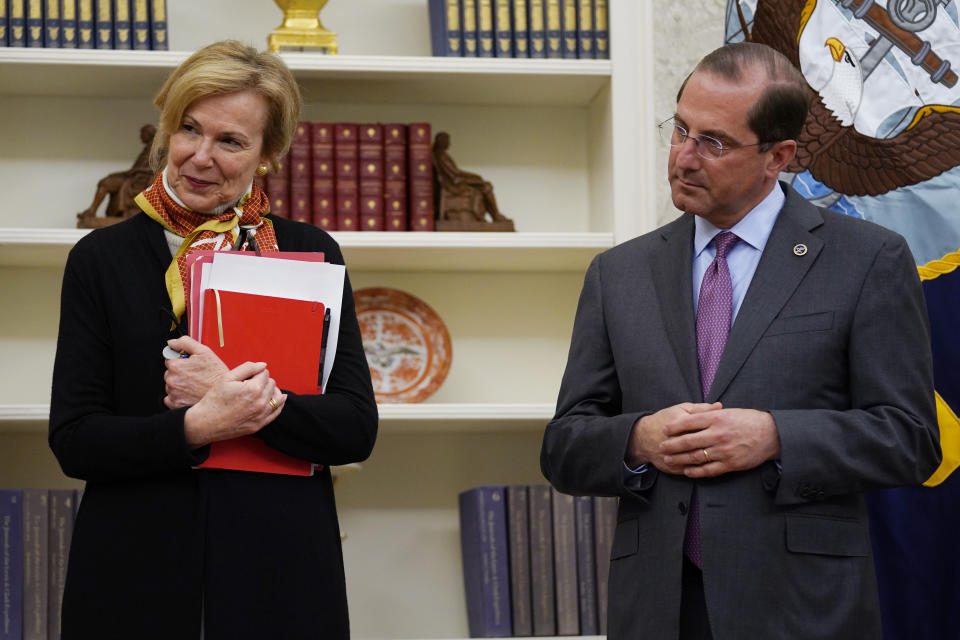 FILE - In this May 6, 2020, file photo, White House coronavirus response coordinator Dr. Deborah Birx, left, and Department of Health and Human Services Secretary Alex Azar, listen during an event in honor of World Nurses Day in the Oval Office of the White House in Washington. Birx was brought into President Donald Trump’s orbit to help fight the coronavirus, she had a sterling reputation as a globally recognized AIDS researcher and a rare Obama administration holdover. Less than 10 months later, her reputation is frayed and her future in President-elect Joe Biden's administration uncertain. (AP Photo/Evan Vucci, File)